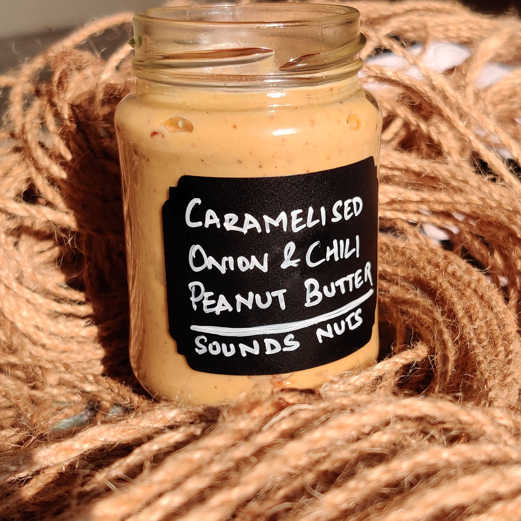 Jar of caramelized onion and chili peanut butter on a jute background